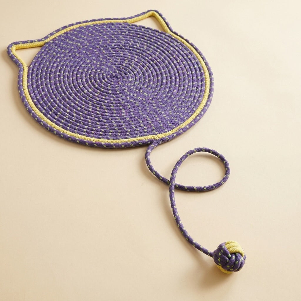 Braided Rope Cat Scratch Mat in purple with play ball, studio shot
