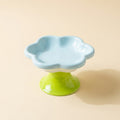 Flower Ceramic Raised Cat Bowl in blue on green pedestal, studio shot