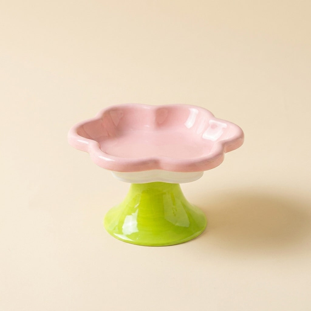 Flower Ceramic Raised Cat Bowl in pink on green pedestal, studio shot