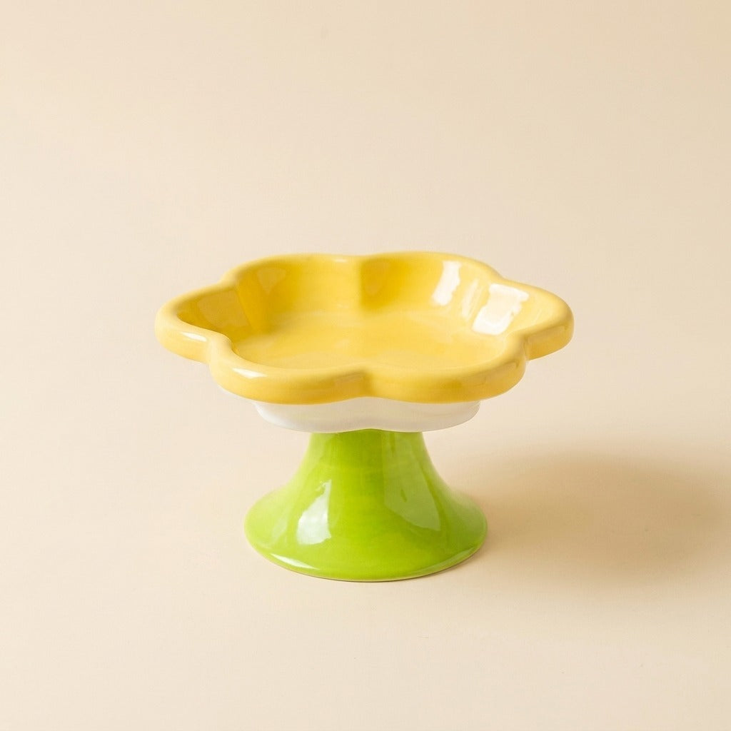 Flower Ceramic Raised Cat Bowl in yellow on green pedestal, studio shot