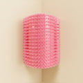 Corner Self Groomer Brush in pink, studio shot