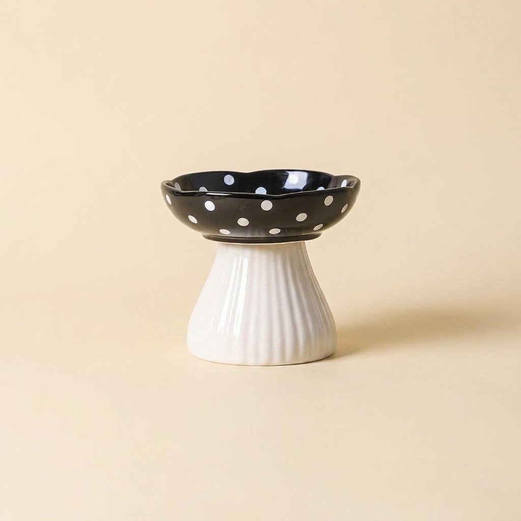 Black Mushroom Elevated Ceramic Cat Bowl with white polka dot cap on ribbed stem, studio shot