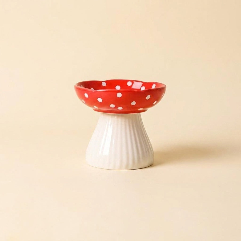 Red Mushroom Elevated Ceramic Cat Bowl with white polka dot cap on ribbed stem, studio shot