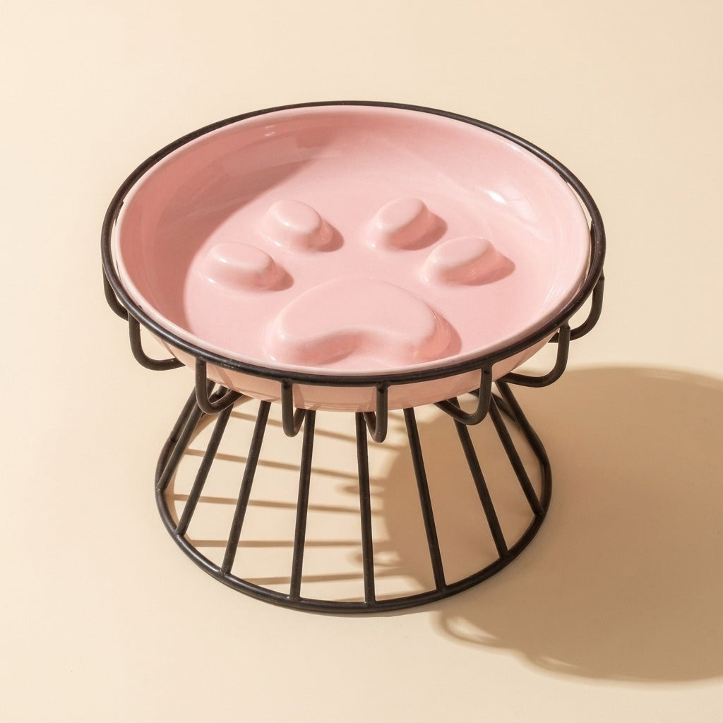 Paw Print Slow Feed Cat Plate in pink on wire stand, studio shot