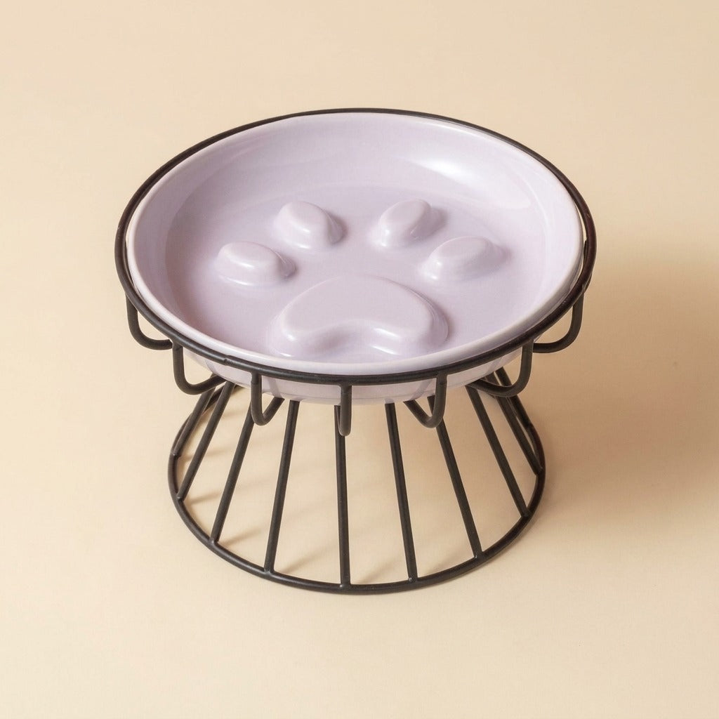 Paw Print Slow Feed Cat Plate in purple on wire stand, studio shot