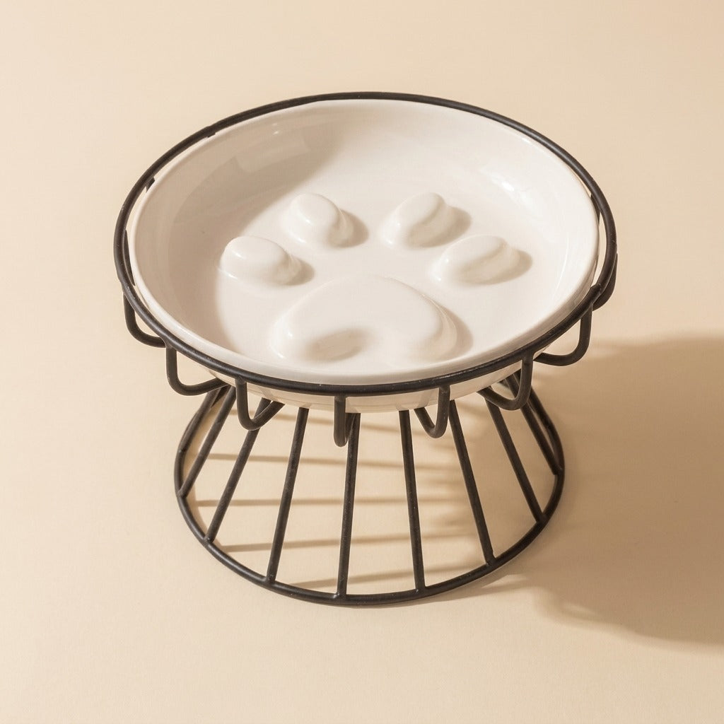 Paw Print Slow Feed Cat Plate in white on wire stand, studio shot