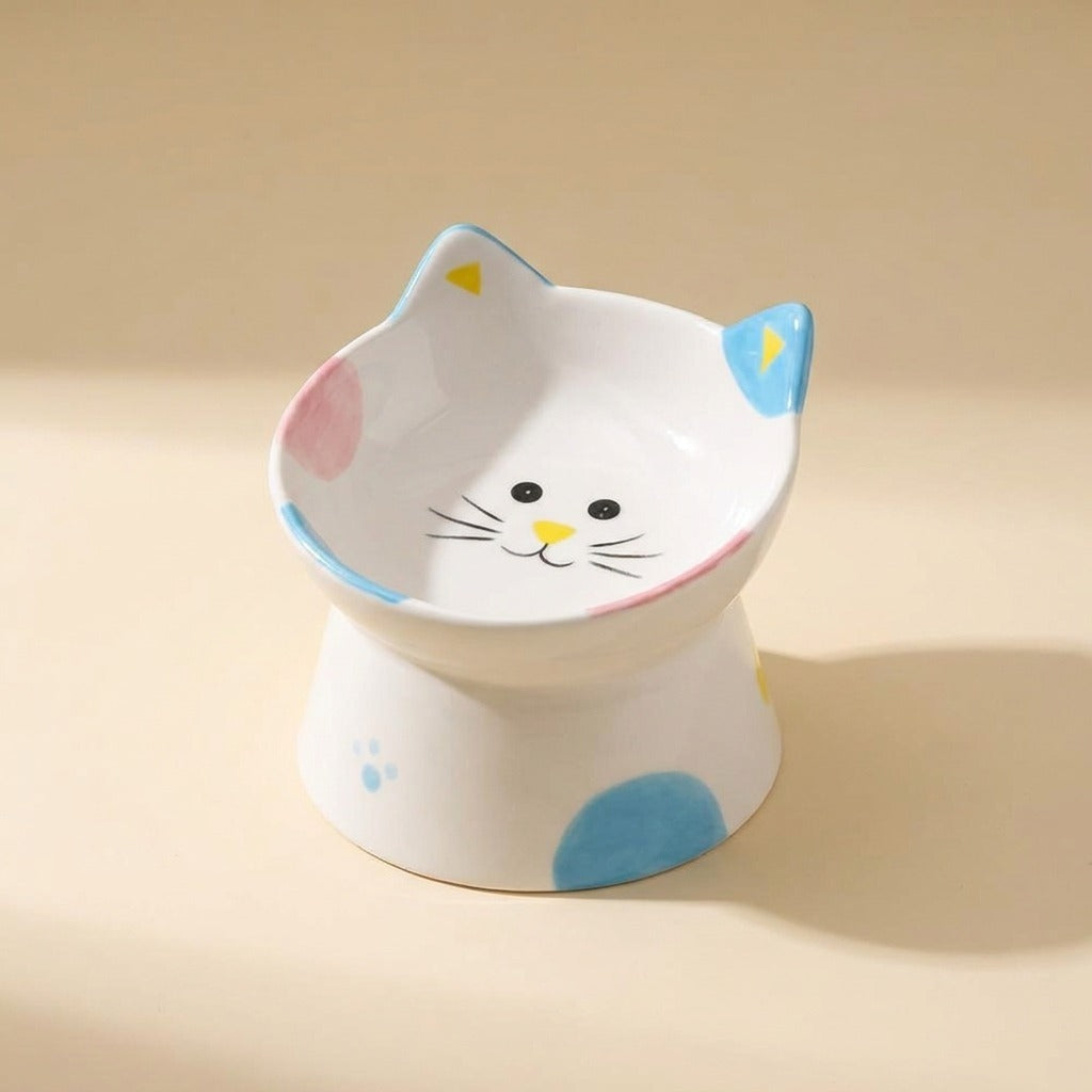 Cat Face Tilted Ceramic Bowl with spots and cat face design, studio shot