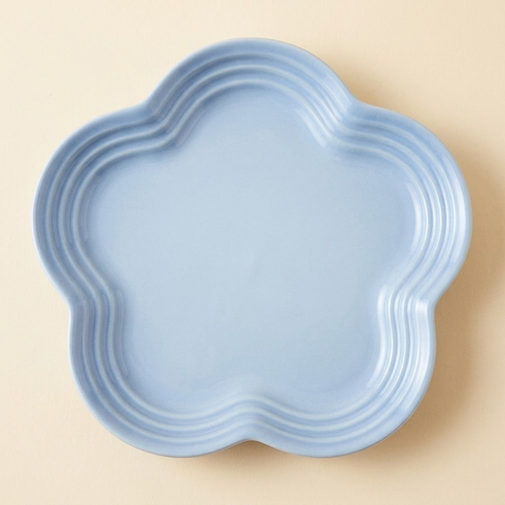 Extra Wide Whisker Relief Ceramic Cat Plate in light blue, flower shaped, studio shot
