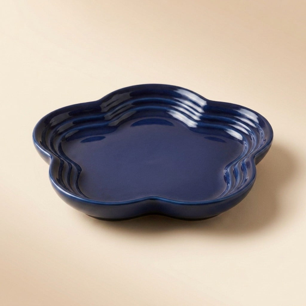 Extra Wide Whisker Relief Ceramic Cat Plate in navy blue, flower shaped, studio shot