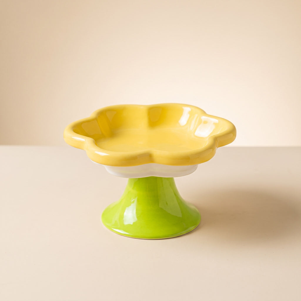 Flower Ceramic Raised Cat Bowl in yellow with green stem on a cream studio background
