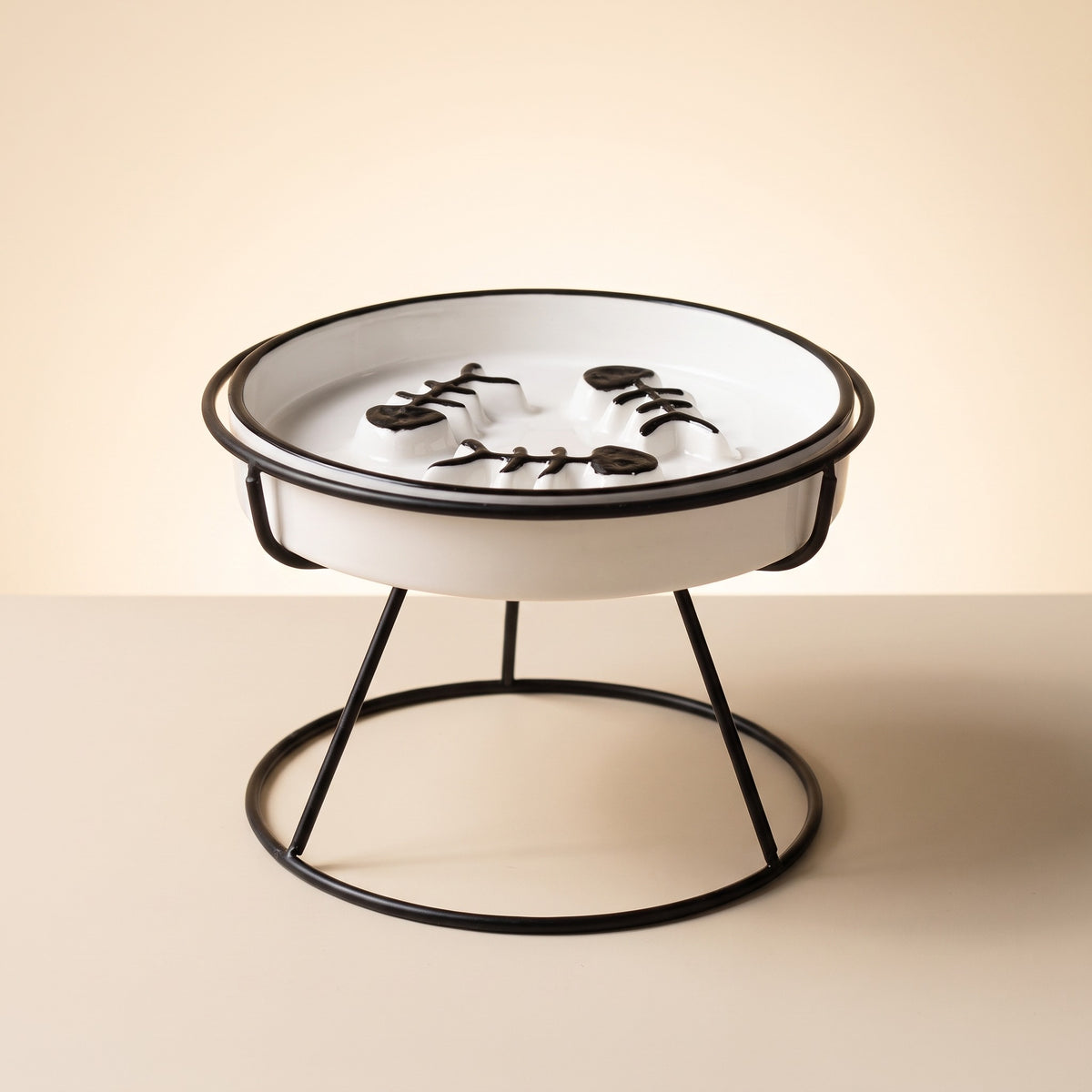 flat face slow feed ceramic dish on metal stand, studio product photo