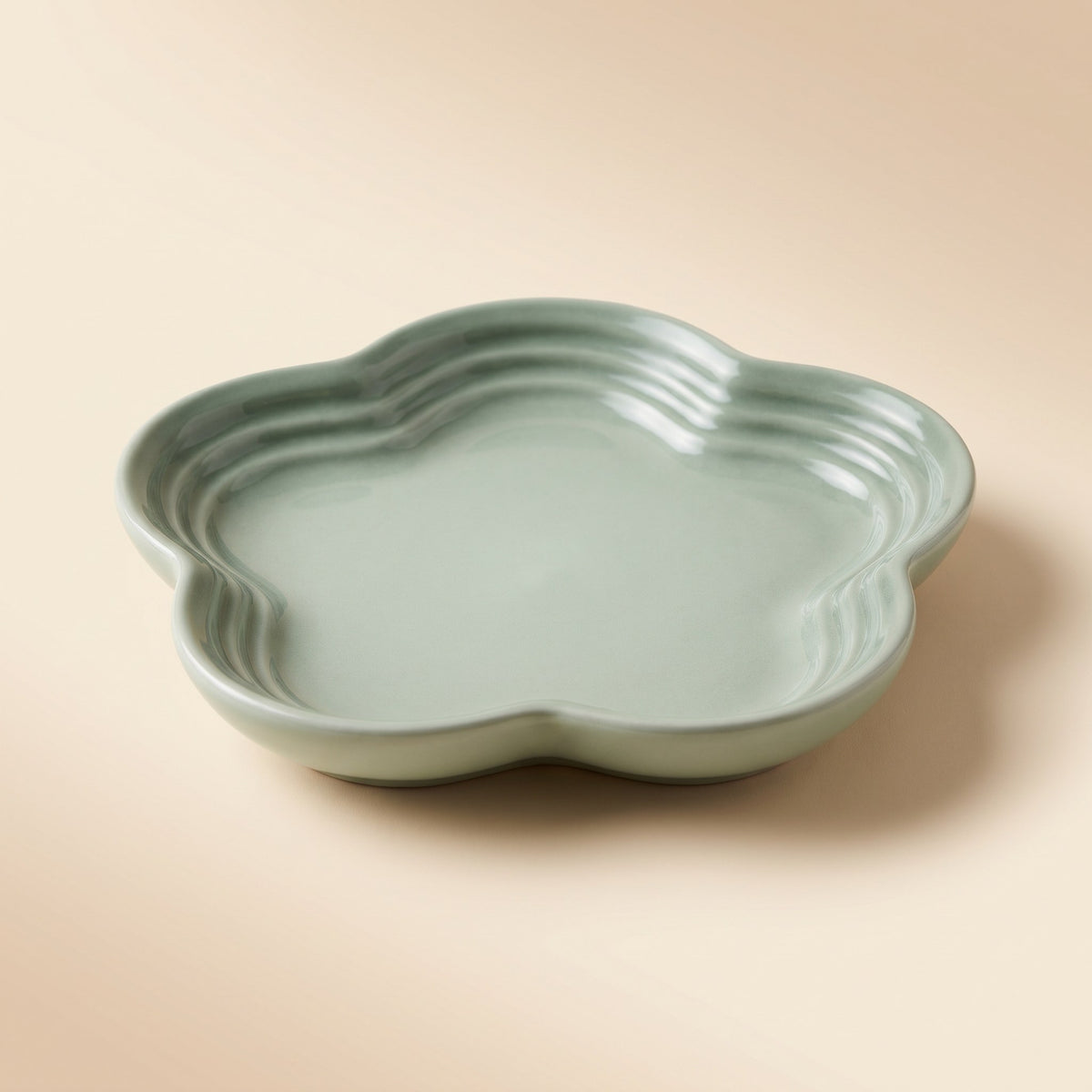 Extra Wide Whisker Relief Ceramic Cat Bowl in sage green, flower shaped shallow dish, studio shot
